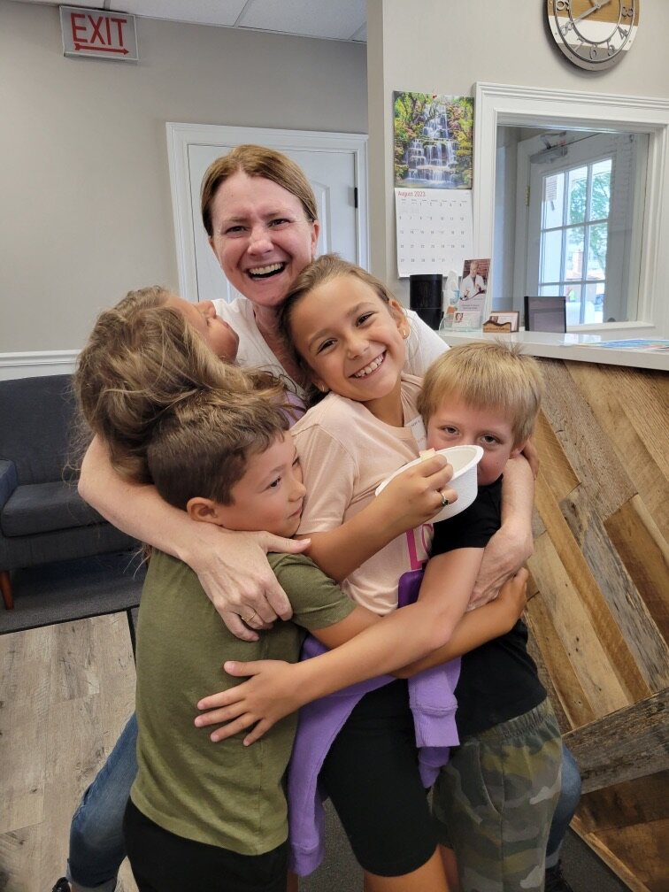 Dr. Carly Smith with Kids at Chiropractic Office in Elmwood Park, IL