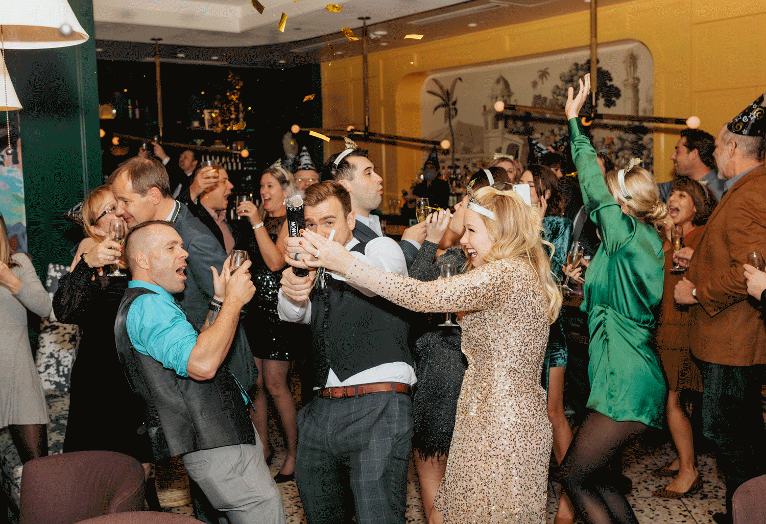 During their New Year’s Eve elopement, a couple pops party poppers, celebrating their love and the start of a new chapter.