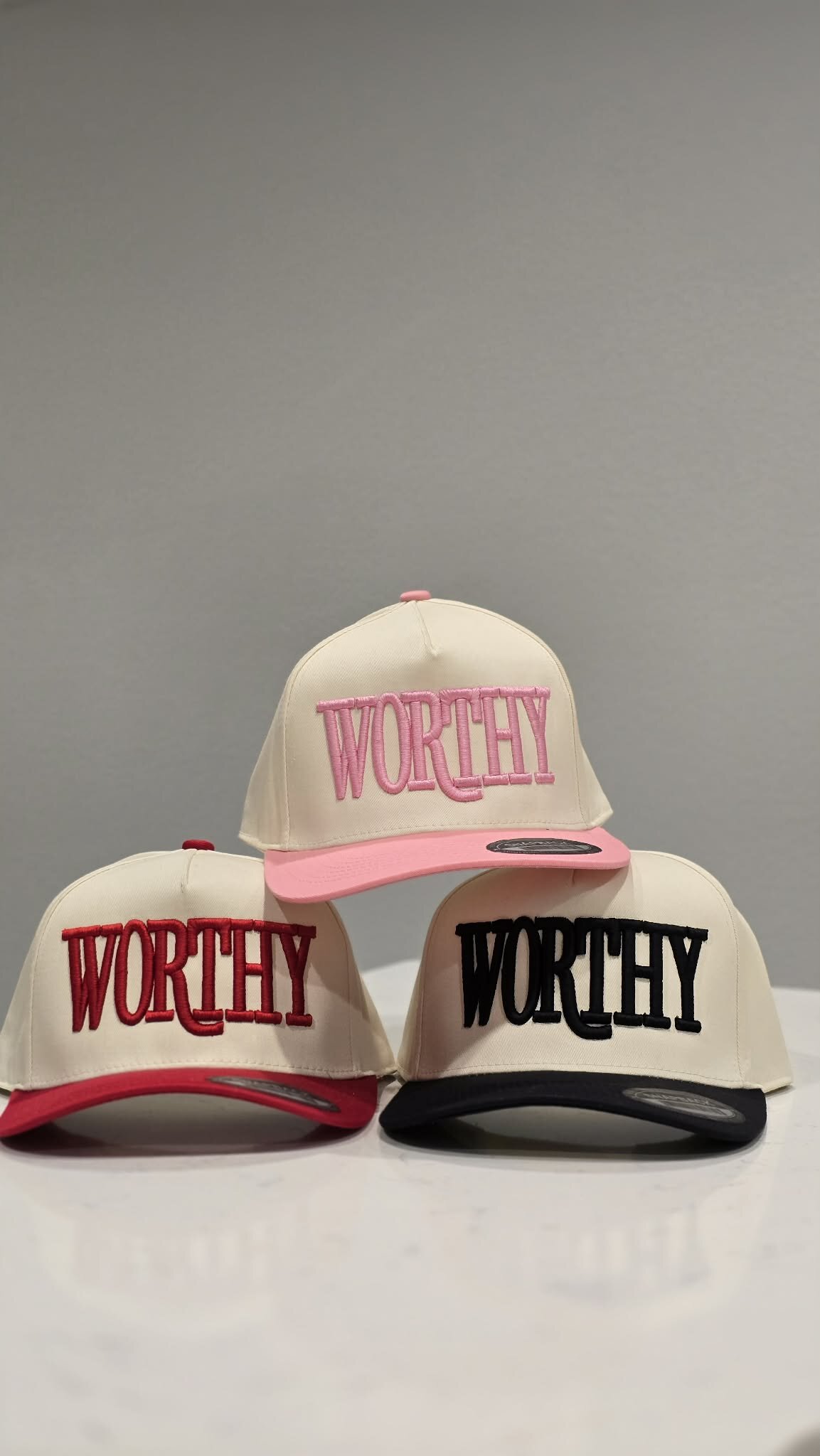 Custom embroidery machine stitching a hat at Hat Stitch in Katy TX