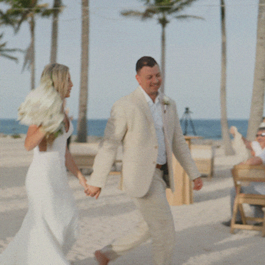 Bride embracing a friend after the ceremony on an Isla Mujeres beach.