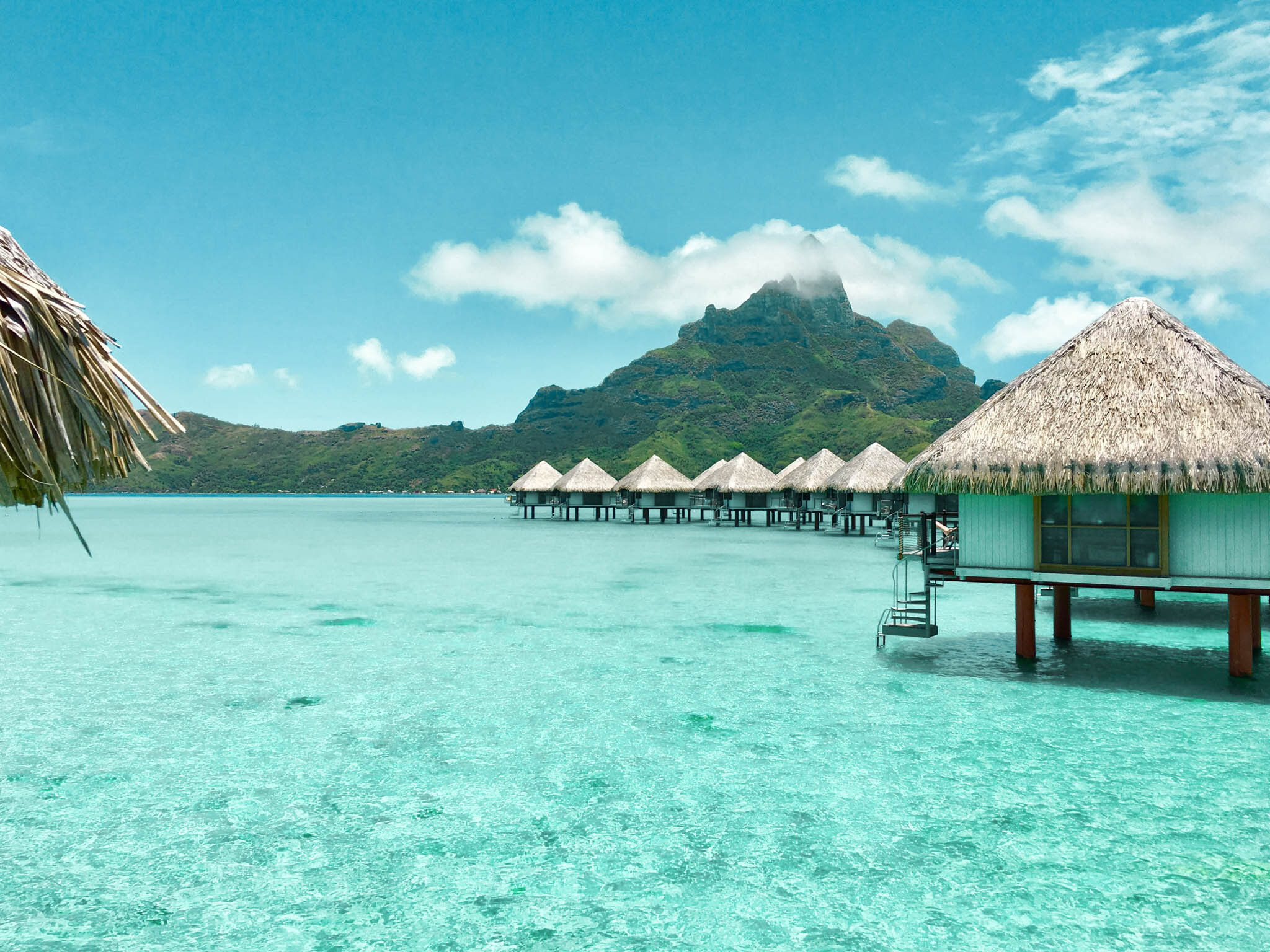 Mom and child on a beach at sunset