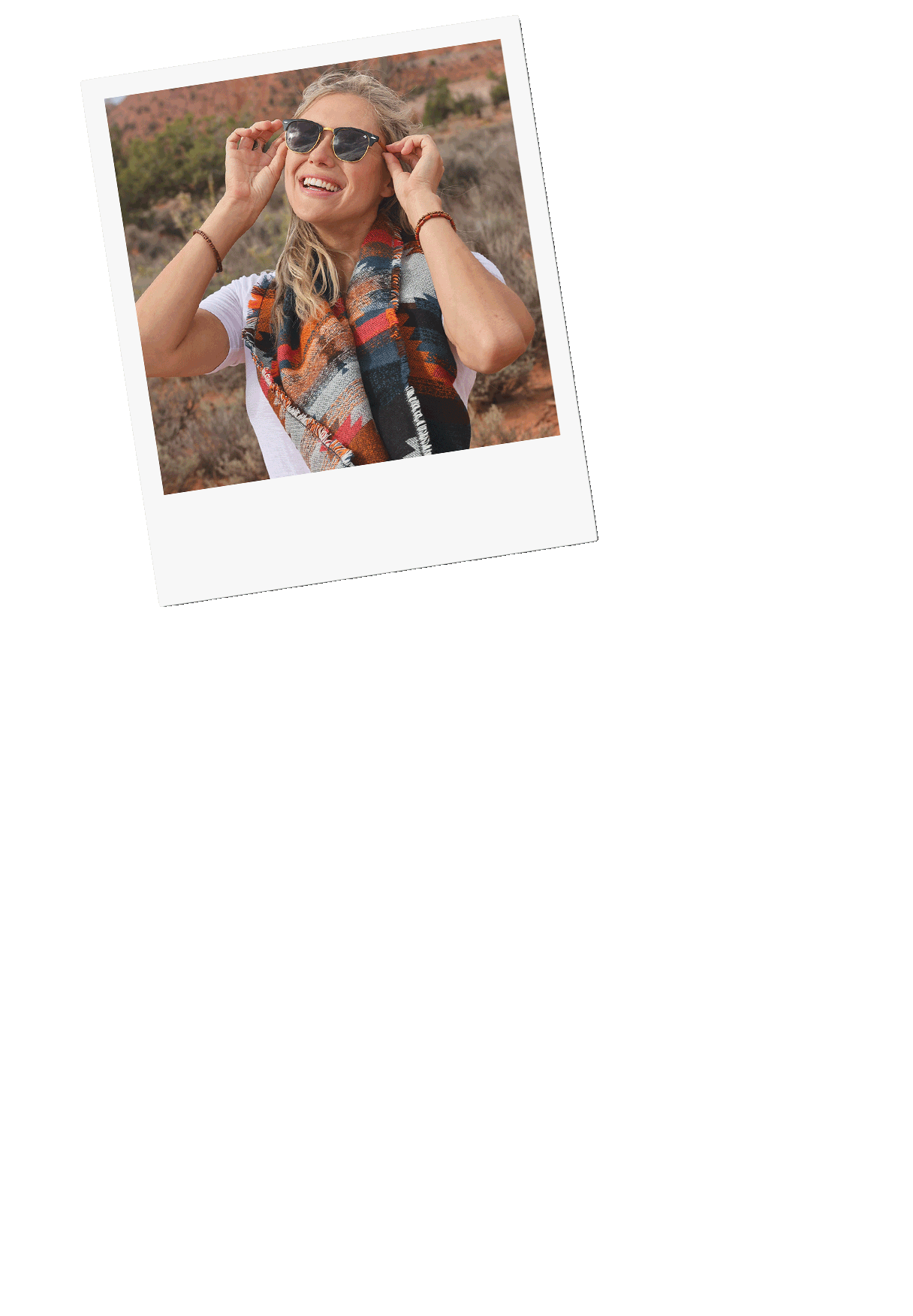 Five polaroid photos that shows a woman with blonde hair smiling in the red desert, holding her laptop. Other images shows a cactus, and camera sitting on a red tribal blanket outside.