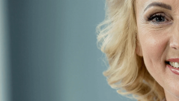 Gif of older woman with blonde hair smiling