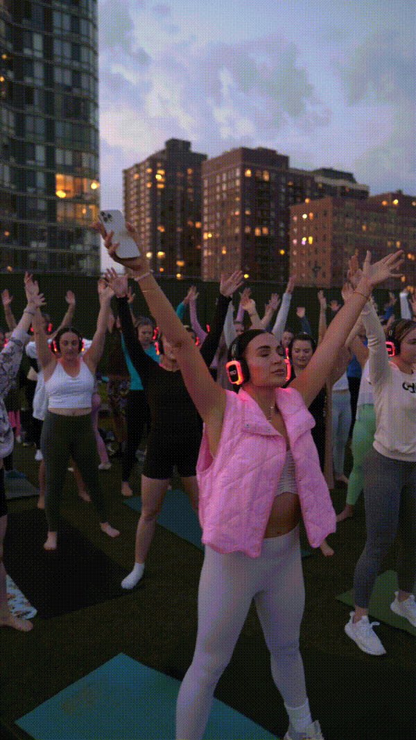 GIF of a group of women with their hands in the air