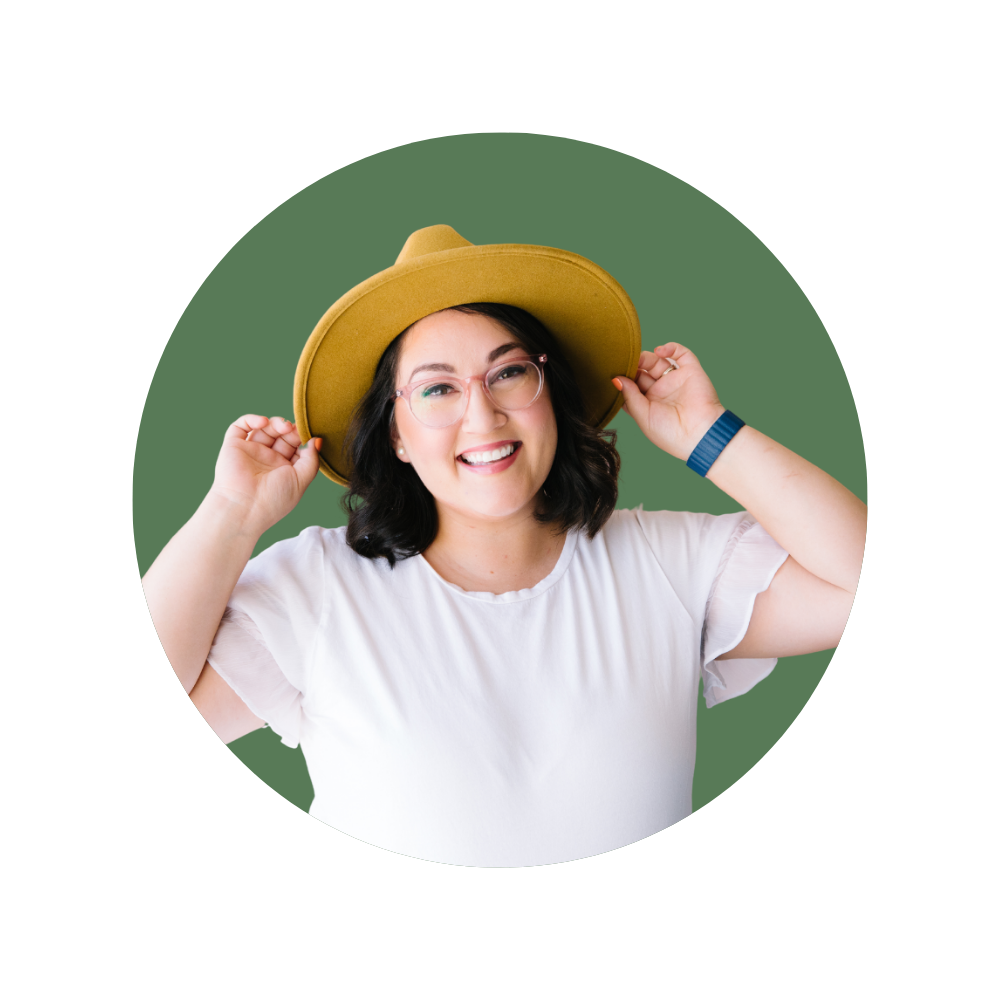 Amy H., a Web Designer Library member, smiling in a white top and mustard hat.