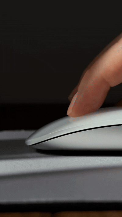Close-up movements of a woman's hand clicking a computer mouse.