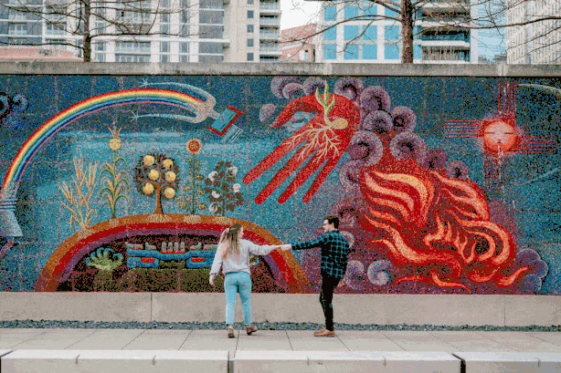 GIF of couple dancing in front of mural during Dallas engagement session