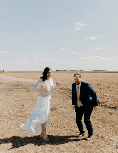 GIF of bride and groom jumping for joy