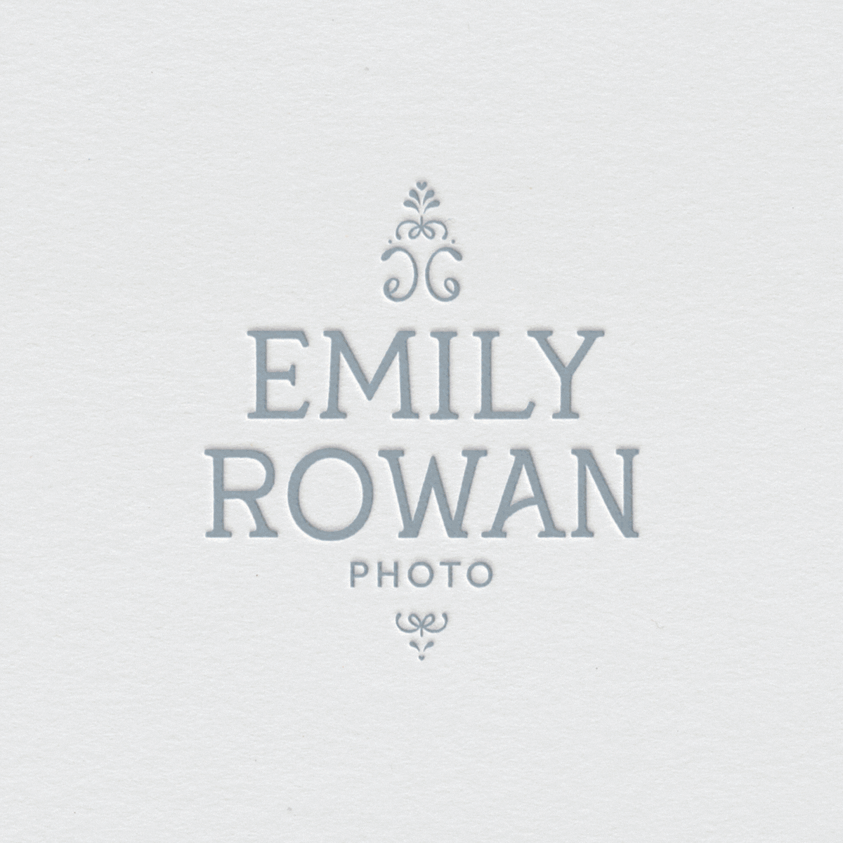 Elegant serif logo design in soft blue for a fine art wedding photographer targeting timeless, sentimental couples