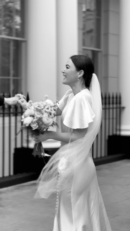 Video snippet of bride in Ghost London bride dress holding bridal bouquet being twirled by the groom on Park Crescent in London