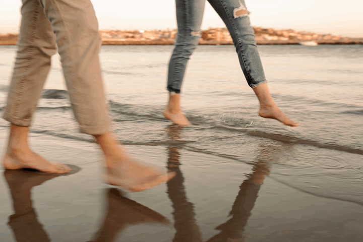 slow motion blur GIF of couples feet in malibu