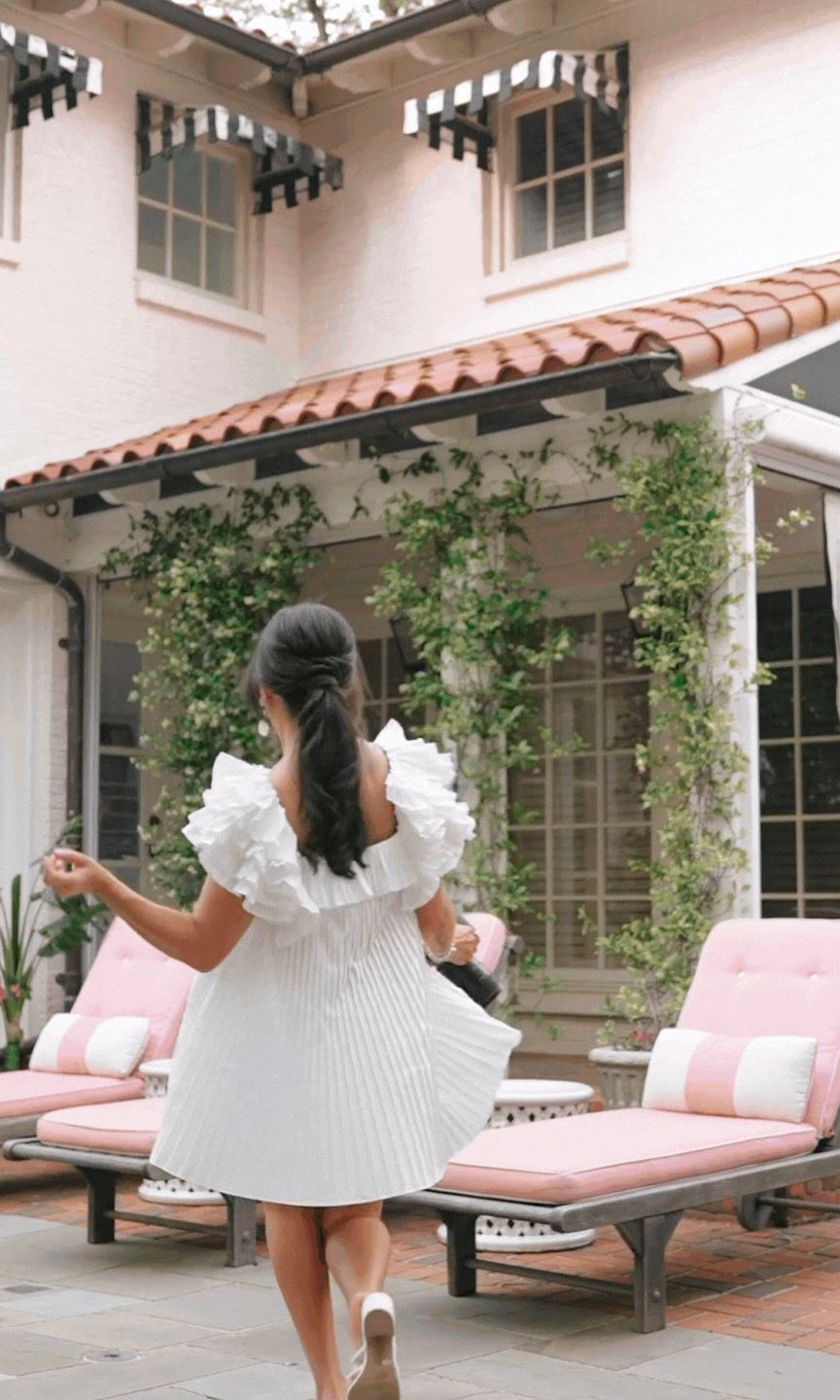 GIF of Cassie Loree skipping and taking photos with her camera