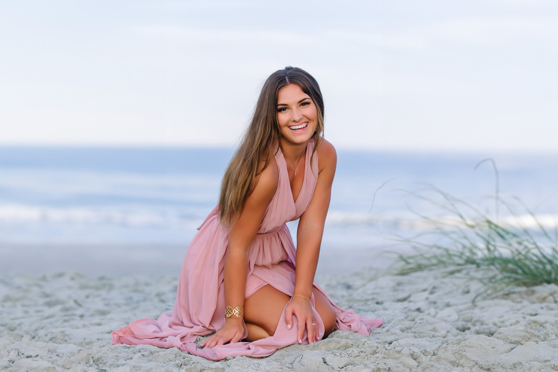 High school senior girl posing on the beach at sunset in Myrtle Beach during a senior photography session