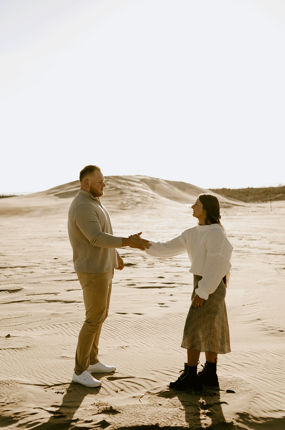 A GIF of a couple doing their handshake at Silver Lake Sand Dunes