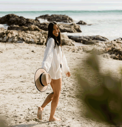 GIF of Amberley turning around and walking on the beach