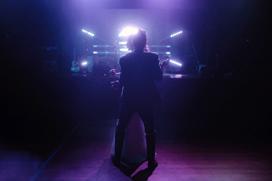 Couple’s first dance under neon lights at their campground wedding in the Poconos with concert-style festival vibes