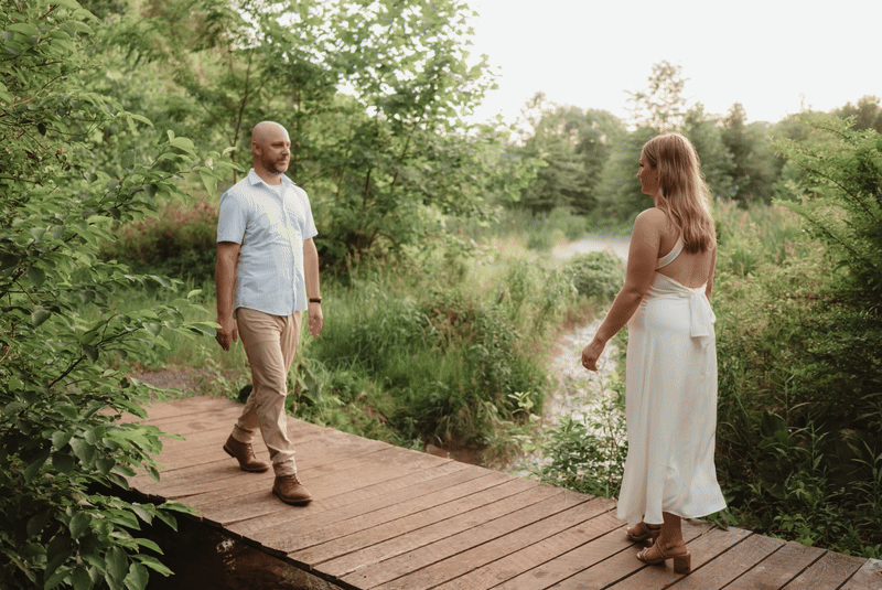 Couple enjoying a photo session on a boardwalk in a park in Pennsylvania