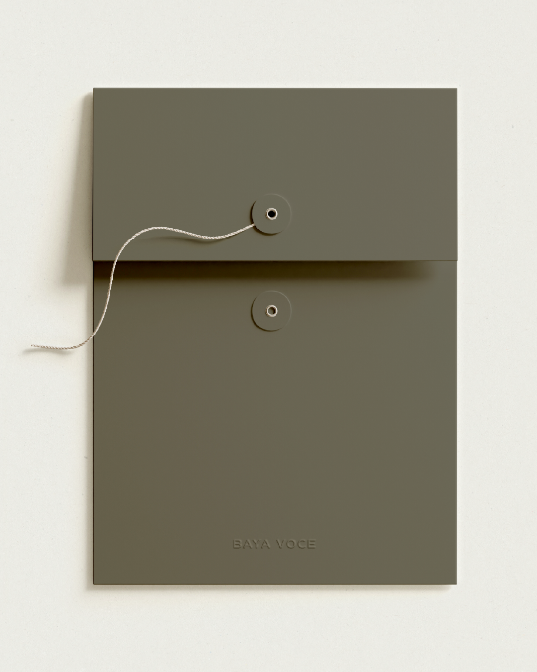 Custom olive green folder with string closure and embossed Baya Voce branding, part of the high-touch client experience.