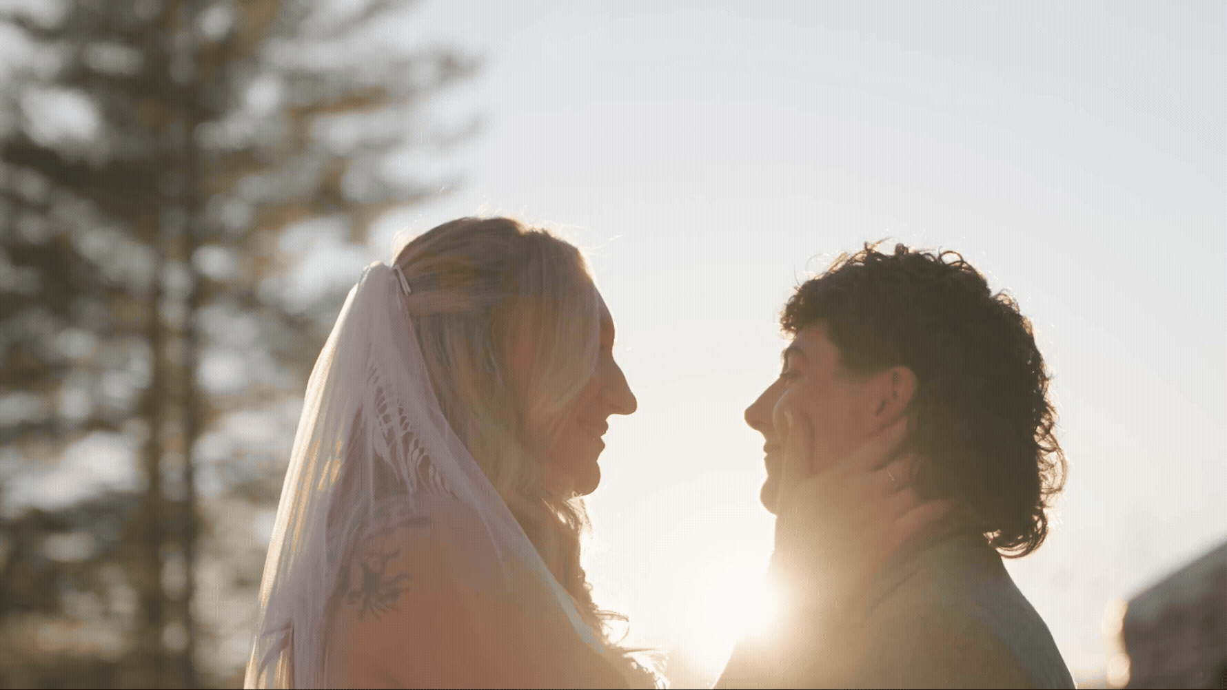 a newlywed couple leaning in for a kiss 