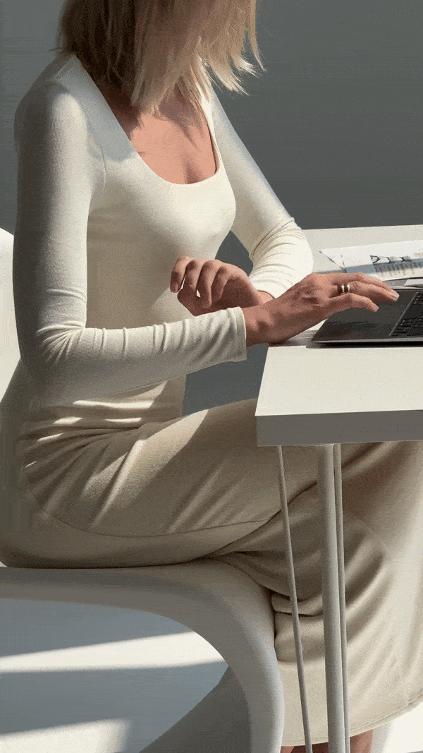 A web designer drinking coffee at her desk to fuel creativity