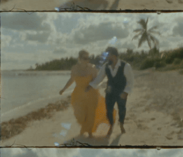 gif of bride and groom running on beach