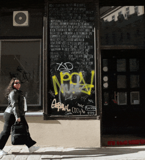 Writer Martina Menzini Walking by Graffiti Buildings in Vienna.