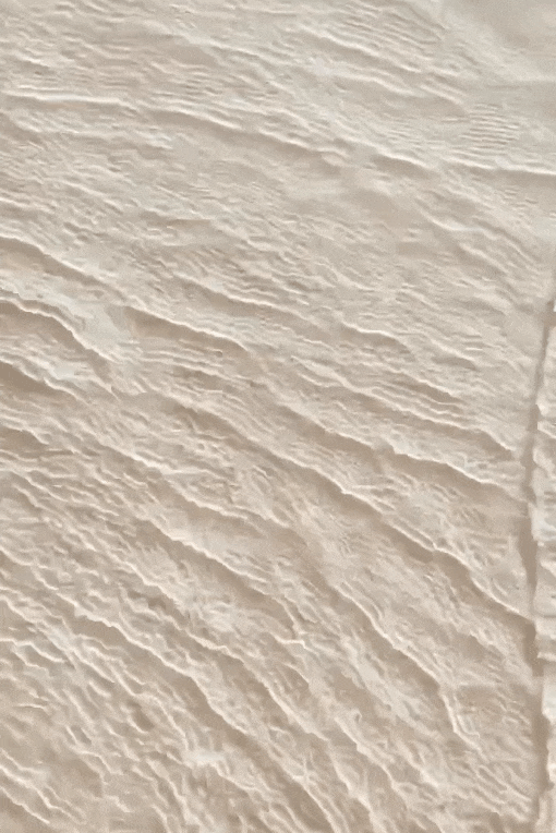 Close-up GIF of water ripples at the beach showcasing endless, mesmerizing patterns and natural tranquility