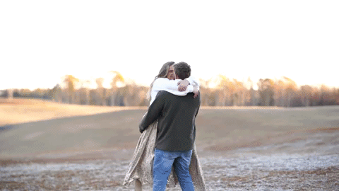 Engagement Video with couple kissing in a field