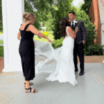 Photographer helping couple on wedding day