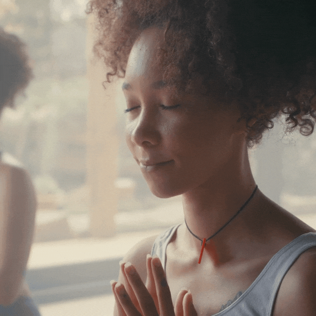 Woman meditating and taking a breath in.