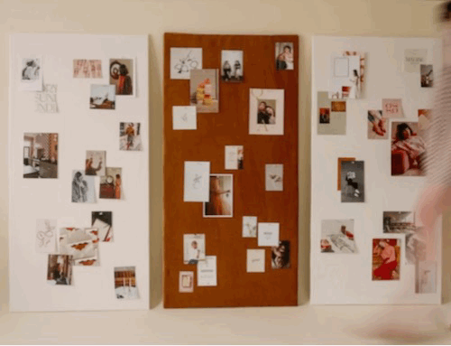 GIF of woman in motion blur walking past collage boards with photos on them