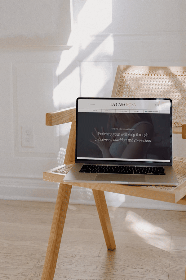 Laptop mockup of a website for La Casa Rosa with a calming video in the hero section, showcasing their philosophy: eat intuitively, move intentionally, and feel connected.