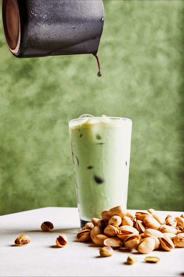 GIF of espresso being poured into a pistachio latte.