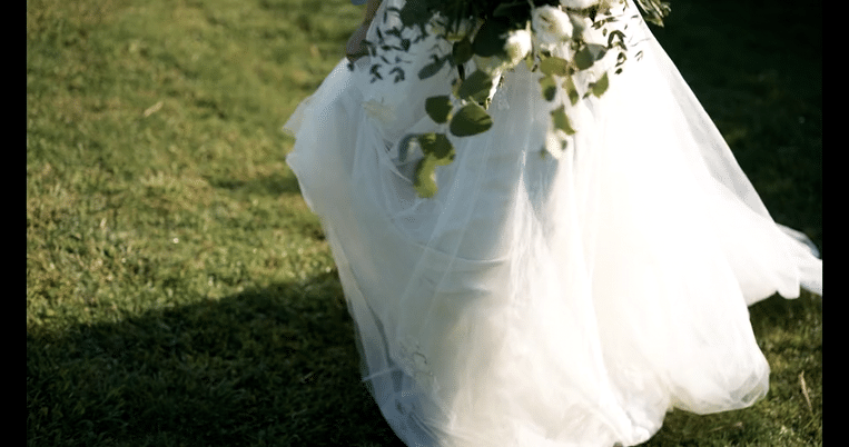 bride walking in grass