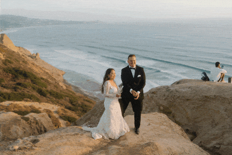 bride and groom walking in front of mountain
