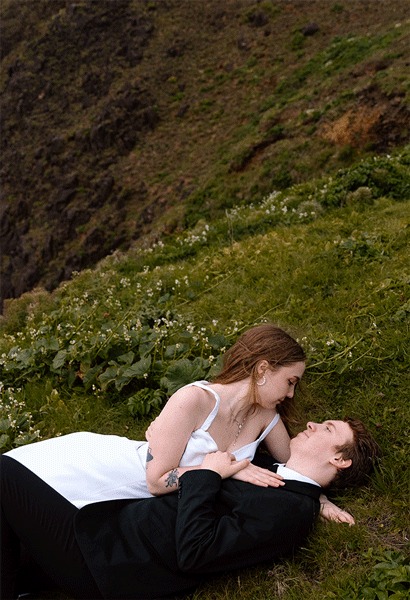 Bride holding up a bouquet of flowers during a beach elopement in Michigan.