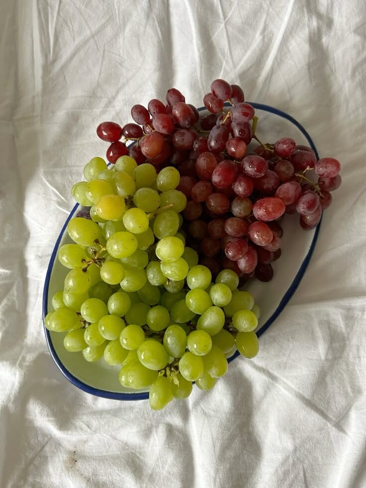 red and green grapes on a white plate