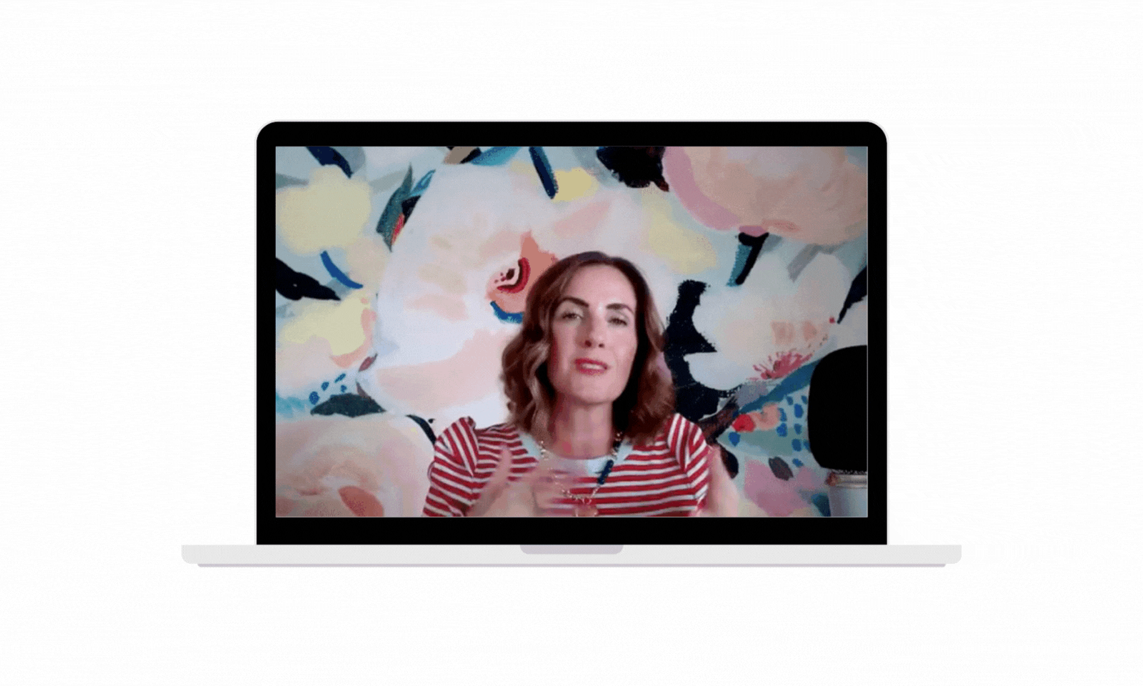 female photographer wearing pink and typing on a laptop computer teaching email marketing