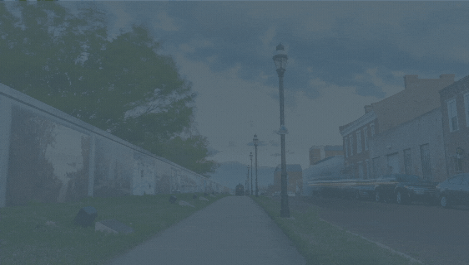 Moving background of the flood walls in Paducah, Kentucky with the clouds in the sky, downtown buildings, light poles.