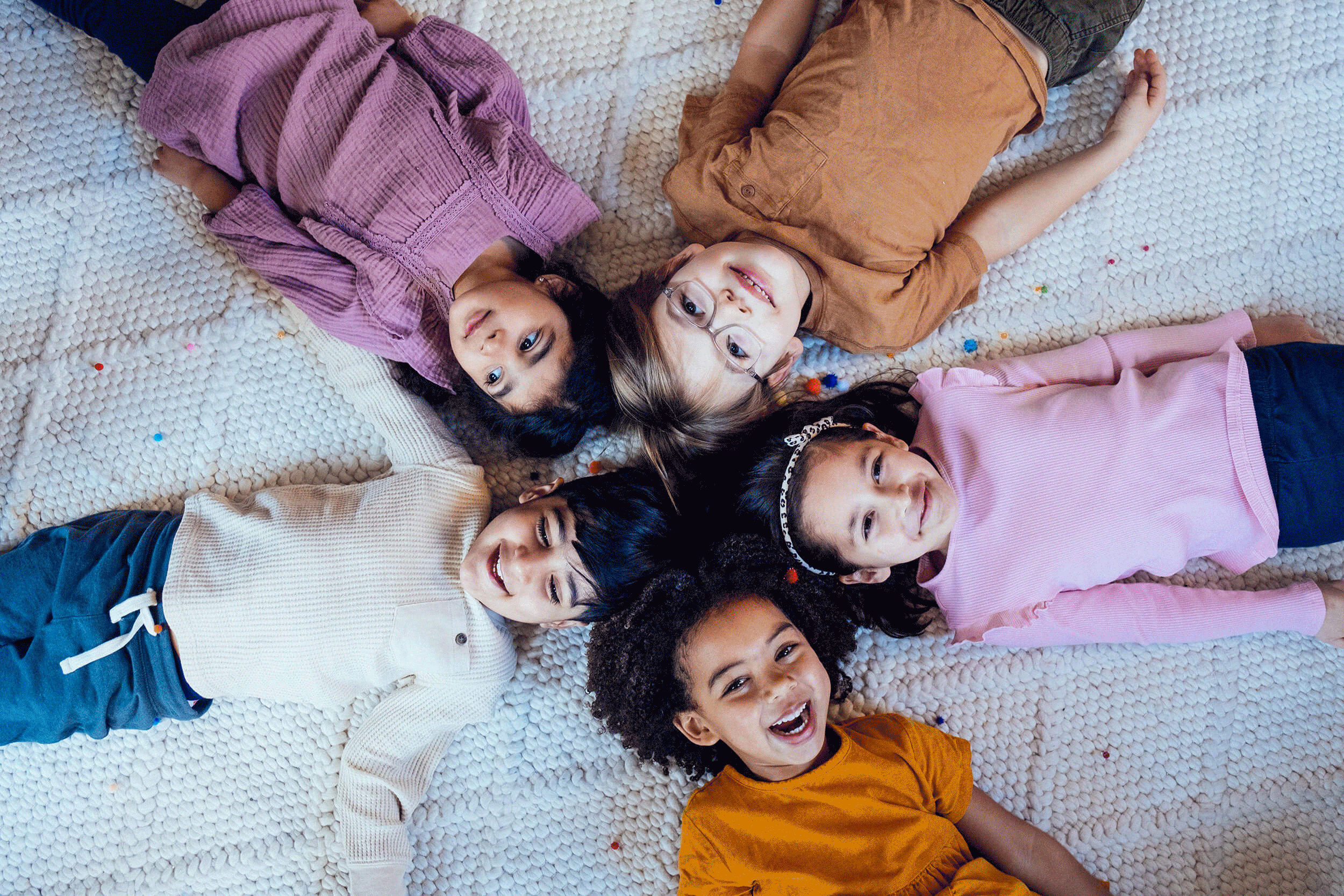 A group of children laying together