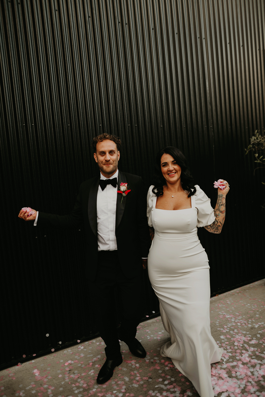 A tattooed couple throw confetti at the camera at The Shack Revolution.