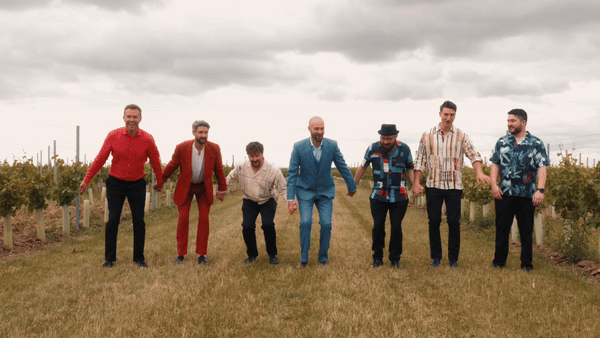 Groom and groomsmen having fun on their wedding day, captured by alternative wedding videographer