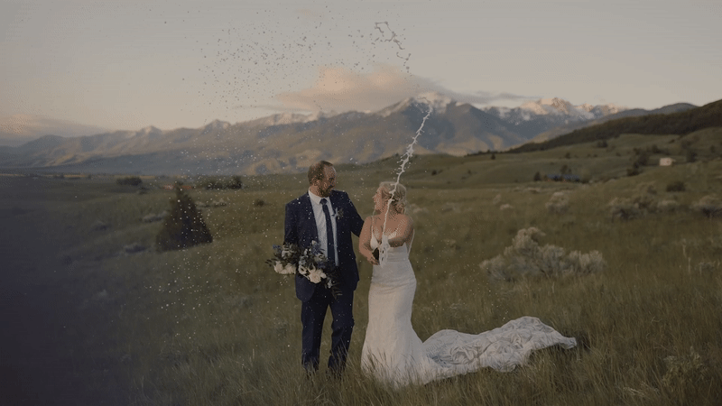 bride and groom popping champagne