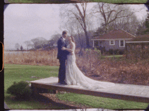 Super 8 wedding film of a bride and groom embracing on a wooden path during their winter wedding in Rhode Island — a timeless analog wedding film moment by Castillo Holliday Photo + Film.