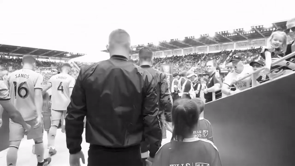 black and white gift of guy walking into stadium