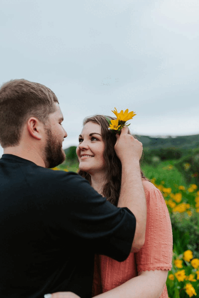 happy couple posing in a flower field for their Idaho photographer