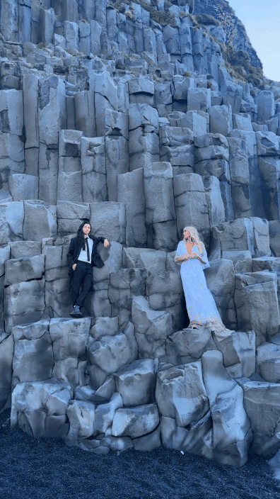 Adventure Iceland elopement couple on rocks at Reynisfjara Black sand beach