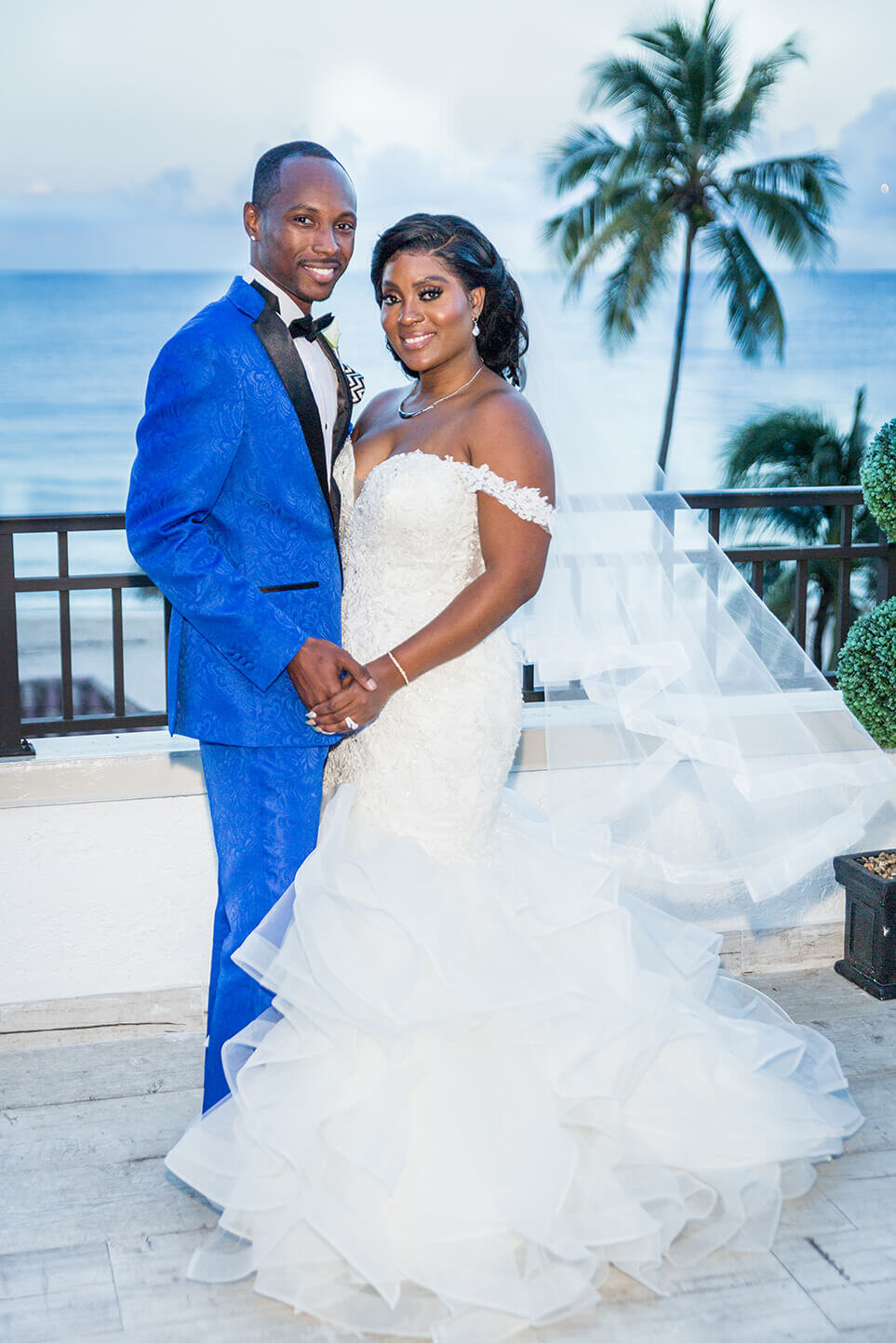 Trish and Alexis pose for newlywed couples photo session on the terrace of Crystal Place Ball Room in Fort Lauderdale Florida.