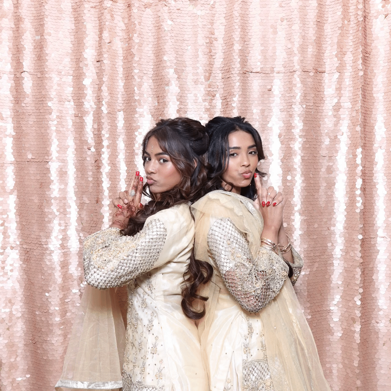 A Gif with 2 Asian girls dressed in traditional outfits, during an Asian Birthday Party celebration with Mad Hat Photo Booth Hire