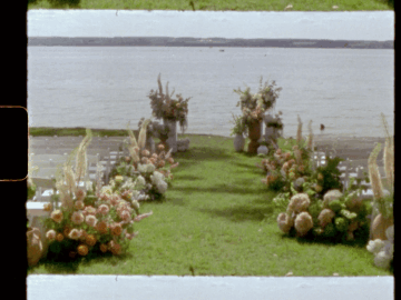 luxury ceremony florals in front of a lake.